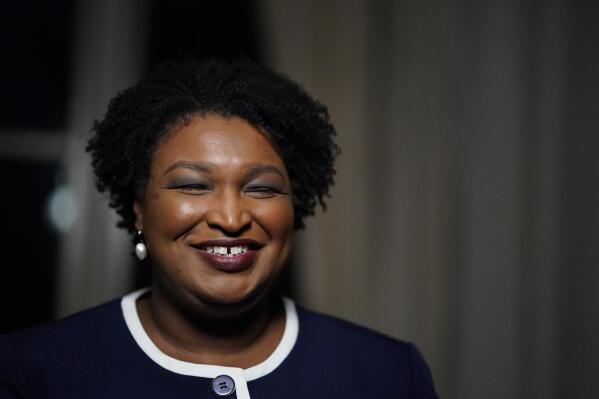 FILE - Then-Georgia gubernatorial Democratic candidate Stacey Abrams speaks during an interview with The Associated Press on Dec. 16, 2021, in Decatur, Ga. Stacey Abrams has used a campaign stop in Atlanta to applaud the push for voting rights in Congress and express support for President Biden. Abrams was noticeably absent from Biden’s visit last week to Atlanta, where he called for an end to the filibuster to pass voting legislation. Abrams said Wednesday, jan. 19, 2022 that she was a proud Democrat and "President Joe Biden is my president.” She took questions from the media at the headquarters of the Georgia AFL-CIO union, which announced that it was endorsing her for Georgia governor. Abrams also said she was proud of the work that was going to happen on Capitol Hill to keep the focus on voting rights. (AP Photo/Brynn Anderson, file)