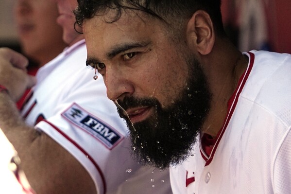 Los Angeles Angels' Anthony Rendon pours water over his head prior to a baseball game against the Los Angeles Angels Sunday, July 2, 2023, in Anaheim, Calif. (AP Photo/Mark J. Terrill)