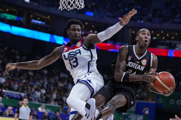 Jordan forward Rondae Hollis Jefferson (24) is fouled by U.S. forward Jaren Jackson Jr. (13) as he shoots during the first half of a Basketball World Cup group C match in Manila, Philippines Wednesday, Aug. 30, 2023. (AP Photo/Michael Conroy)