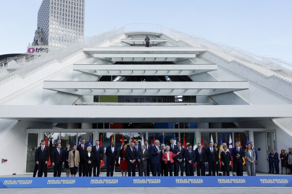 Leaders from EU and Western Balkans countries stand for a family photo in front of Pyramid Hall after Berlin Process Leaders' Summit in Tirana, Albania, Monday, Oct. 16, 2023. Leaders from the European Union and the Western Balkans hold a summit in Albania's capital to discuss the path to membership in the bloc for the six countries of the region. (AP Photo/Franc Zhurda)