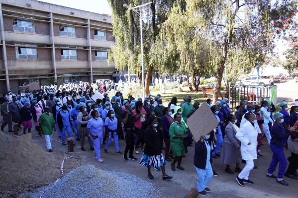 Health workers led by nurses take part in a demonstration over salaries at Parerenyatwa Hospital in Harare, Tuesday, June, 21, 2022. A strike by health workers has left Zimbabwe's major hospitals in near paralysis, putting further strain on a public health system already in a dire state. (AP Photo/Tsvangirayi Mukwazhi)
