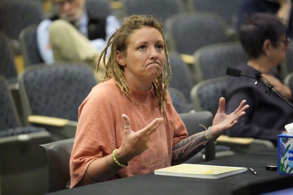 Cara Lamb, ex-wife of shooter Robert Card, testifies, Thursday, May 16, 2024, in Augusta, Maine, during a hearing of the independent commission investigating the law enforcement response to the mass shooting in Lewiston, Maine. (AP Photo/Robert F. Bukaty)