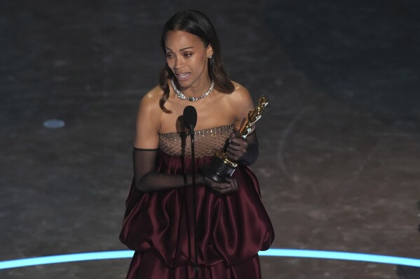 Zoe Saldana accepts the award for best performance by an actress in a supporting role for "Emilia Perez" during the Oscars on Sunday, March 2, 2025, at the Dolby Theatre in Los Angeles. (AP Photo/Chris Pizzello)