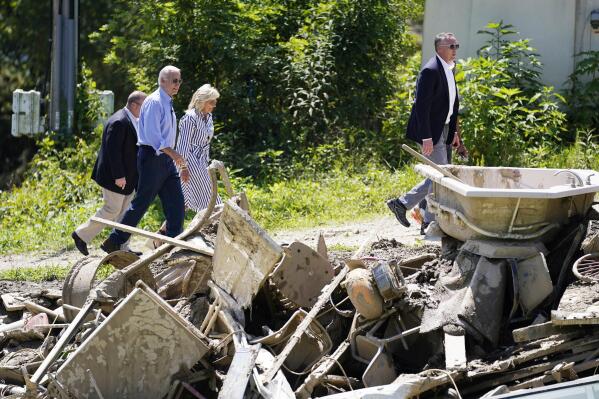 President Joe Biden and first lady Jill Biden, tour a neighborhood impacted by flooding, Monday, Aug. 8, 2022, in Lost Creek, Ky. (AP Photo/Evan Vucci)