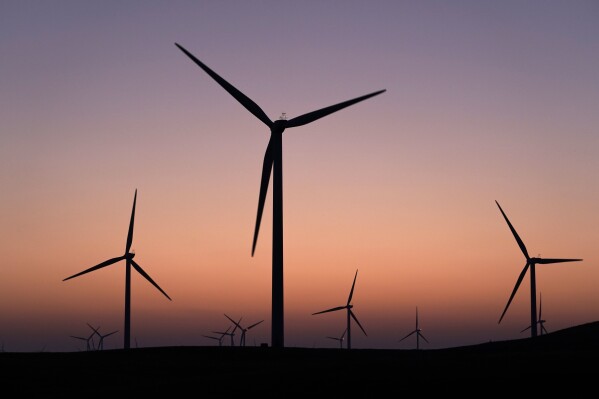 FILE - A wind farm operates at dusk in rural Solano County, Calif., Aug. 30, 2023. (AP Photo/Godofredo A. Vásquez, File)