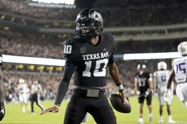 Texas A&M quarterback Marcel Reed (10) reacts after scoring a touchdown against LSU during the third quarter of an NCAA college football game Saturday, Oct. 26, 2024, in College Station, Texas. (AP Photo/Sam Craft)