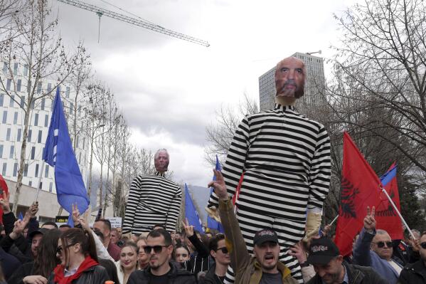 Demonstrators hold a puppet, depicting Albanian Prime Minister Edi Rama, during an anti-government rally, in Tirana, Albania, Friday, March 3, 2023. Thousands of supporters of Albania's political opposition on Friday held an anti-government protest, calling for the prime minister's resignation for alleged corruption and mishandling of the small Balkan nation's economy. (AP Photo/Franc Zhurda)
