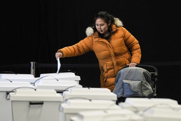 A woman casts her votes in parliamentary elections in Nuuk, Greenland, Tuesday, March 11, 2025. (AP Photo/Evgeniy Maloletka)
