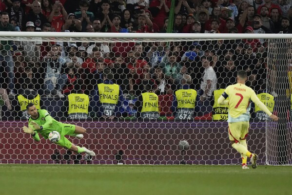 Portugal goalkeeper Diogo Costa makes a save against Spain's Alvaro Morata during the penalty shootout of the Nations League final soccer match between Portugal and Spain at the Allianz Arena in Munich, Germany, Sunday, June 8, 2025. (AP Photo/Matthias Schrader)