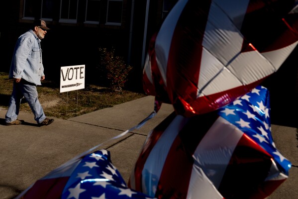 A resident walks into their voting precinct after voting on the morning of the South Carolina Republican primary at New Bridge Academy in Cayce, S.C., Saturday, Feb. 24, 2024. (AP Photo/Andrew Harnik)