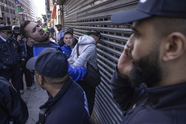 NYPD officers arrest a person during a demonstration in support of Palestinian activist Mahmoud Khalil, Tuesday, March 11, 2025, in New York. (AP Photo/Yuki Iwamura)