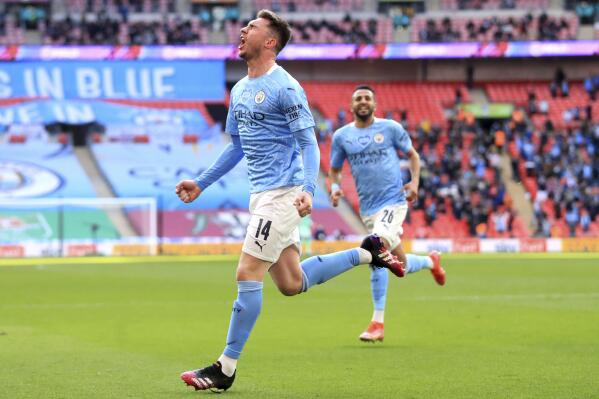 Manchester City's Aymeric Laporte celebrates scoring their side's first goal of the game during the English League Cup Cup Final against Tottenham Hotspur at Wembley Stadium, London, Sunday April 25, 2021. (Adam Davy/PA via AP)