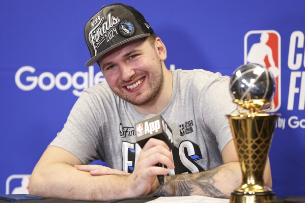 Dallas Mavericks guard Luka Doncic smiles during a news conference after the team's win over the Minnesota Timberwolves in Game 5 of the NBA basketball Western Conference finals Thursday, May 30, 2024, in Minneapolis. (AP Photo/Matt Krohn)