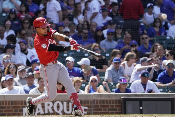 Cincinnati Reds' Santiago Espinal hits a two-run home run against the Chicago Cubs during the seventh inning of a baseball game Friday, May 31, 2024, in Chicago. (AP Photo/David Banks)