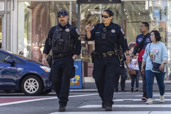 Officers with the San Francisco Police Department patrol in San Francisco's Union Square, Sunday, Sept. 1, 2024, the morning after San Francisco 49ers rookie wide receiver Ricky Pearsall was shot in the chest during an attempted robbery nearby. (Stephen Lam/San Francisco Chronicle via AP)