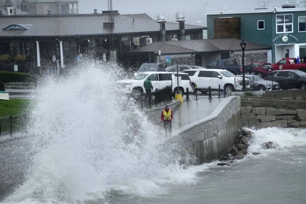 A city worker views a wave crashing along a walkway during storm Lee, Saturday, Sept. 16, 2023, in Bar Harbor, Maine. (AP Photo/Robert F. Bukaty)