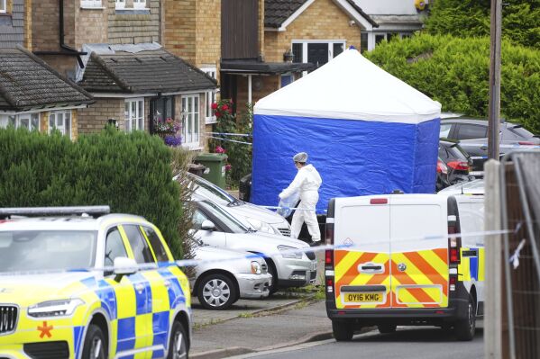 A forensic officer at the scene in Ashlyn Close, Bushey, after an incident on Tuesday evening, in Hertfordshire, England, Wednesday, July 10, 2024. (Jacob King/PA via AP)