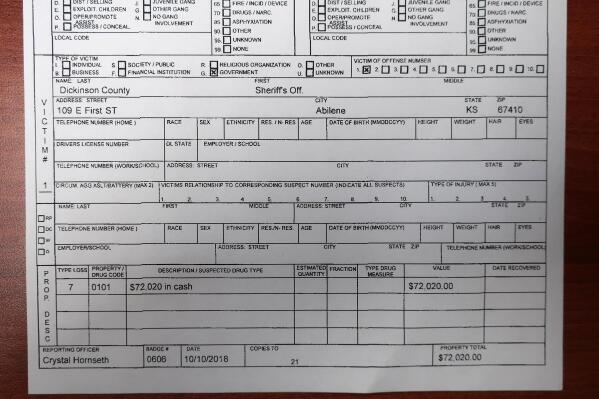 This Friday, April 23, 2021 photo shows the bottom part of a report filed by a Kansas Bureau of Investigation agent on Oct. 10, 2018, about $72,020 in cash missing from the custody of the Dickinson County Sheriff's Department sometime after a January 2017 drug bust. There's still no official explanation for what happened to the cash, despite KBI investigations. (AP Photo/John Hanna)