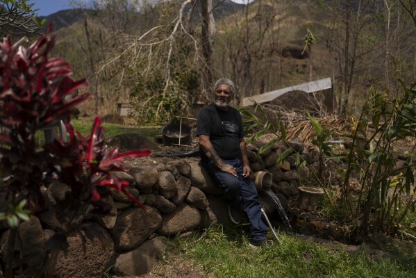 Keʻeaumoku Kapu poses for photos on his taro farm near Lahaina, Hawaii, Wednesday, Aug. 16, 2023. A deadly Maui wildfire is renewing tensions over Maui stream water rights. (AP Photo/Jae C. Hong)