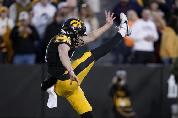 FILE - Iowa punter Tory Taylor punts during the second half of an NCAA college football game against Illinois, Saturday, Nov. 18, 2023, in Iowa City, Iowa. The Chicago Bears waived punter Trenton Gill on Wednesday, May 1, 2024, after drafting Iowa's Tory Taylor in the fourth round last week. Taylor set an NCAA mark last year with 4,479 yards punting while playing for a team with the worst offense in the nation. (AP Photo/Charlie Neibergall, FIle)