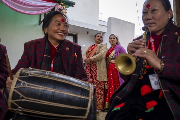 Members of Shrijanshil Mahila Sanstha, or the Self-Reliant Women’s Group, play at a wedding in Kathmandu, Nepal, Wednesday, March 6, 2024. (AP Photo/Niranjan Shrestha)