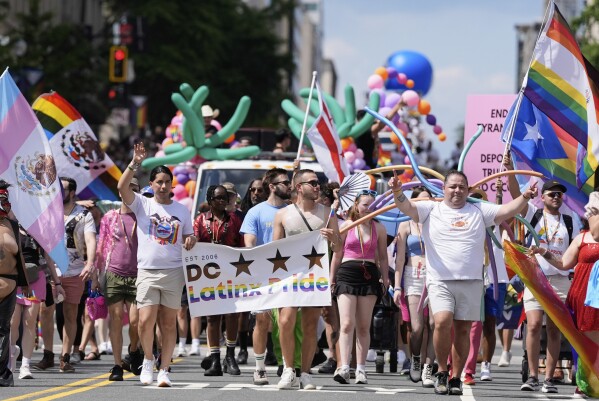 Participants march during the World Pride parade, Saturday, June 7, 2025, in Washington. (AP Photo/Mark Schiefelbein)