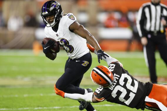 Cleveland Browns safety Grant Delpit (22) trips up Baltimore Ravens wide receiver Devin Duvernay during the first half of an NFL football game, Saturday, Dec. 17, 2022, in Cleveland. (AP Photo/Ron Schwane)