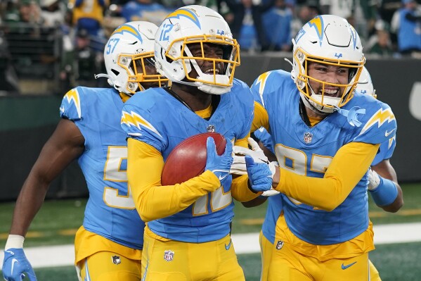 Los Angeles Chargers wide receiver Derius Davis, left, celebrates with teammates after scoring a touchdown against the New York Jets during the first quarter of an NFL football game, Monday, Nov. 6, 2023, in East Rutherford, N.J. (AP Photo/Seth Wenig)