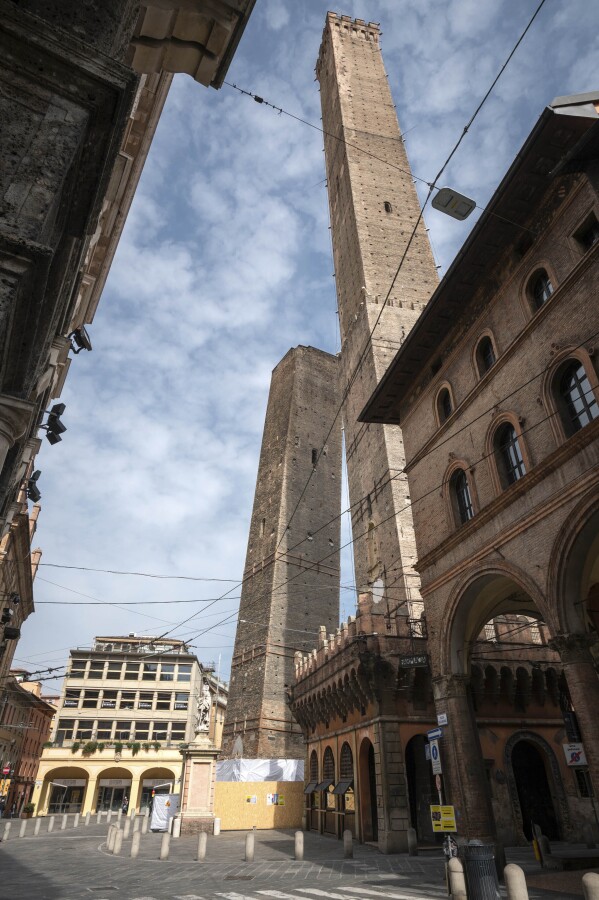 The Garisenda, left, and Asinelli towers are pictured in Bologna, Italy, March 20, 2020. Bologna's Garisenda tower has been locked down for fear it could collapse. Authorities have provided a security cordon in case of collapse.The Garisenda tower along with the Asinelli(97meters)tower is one of the beauties and attractions for tourists visiting Bologna, and a landmark for citizens. (Massimo Paolone, Lapresse Via AP)
