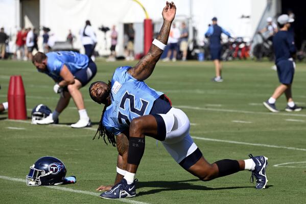 Tennessee Titans running back Derrick Henry (22) stretches before a combined NFL football training camp with the Tampa Bay Buccaneers, Thursday, Aug. 18, 2022, in Nashville, Tenn. (AP Photo/Mark Zaleski)
