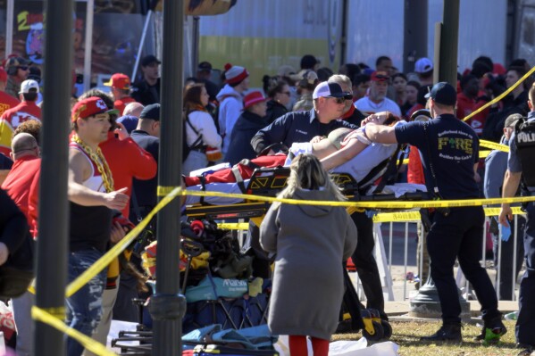 A woman is taken away in an ambulance after an accident following the NFL's Kansas City Chiefs Super Bowl celebration in Kansas City, Missouri, Wednesday, Feb. 14, 2024. The Chiefs defeated the San Francisco 49ers on Sunday in Super Bowl 58. ( AP Photo/Reid Hoffman )