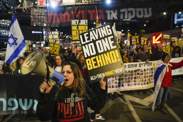 Friends and relatives of the Israeli hostages held in the Gaza Strip by the Hamas militant group attend a rally calling for their release, in Tel Aviv, Israel, Saturday, March 9, 2024. With each passing day, the relatives of hostages in Gaza face a deepening despair. (AP Photo/Ariel Schalit)