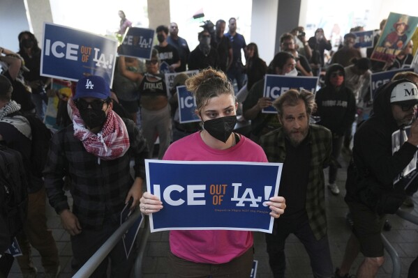 Protesters gather at the U.S. Department of Justice Federal Bureau of Prisons after federal immigration authorities conducted an operation on Friday, June 6, 2025, in Los Angeles. (AP Photo/Jae C. Hong)