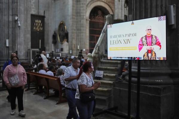 An image of the newly elected Pope Leo XIV fills a screen during Mass at the Metropolitan Cathedral in Mexico City, after his election, Thursday, May 8, 2025. (AP Photo/Eduardo Verdugo)