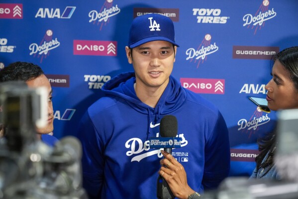 Los Angeles Dodgers' Shohei Ohtani speaks with reporters before a baseball game against the Washington Nationals at Nationals Park, Wednesday, April 24, 2024, in Washington.(AP Photo/Alex Brandon)
