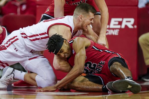 Wisconsin's Chris Vogt, left, and Illinois State's Kendall Lewis (22) scrap for the ball during the first half of an NCAA college basketball game Wednesday, Dec. 29, 2021, in Madison, Wis. (AP Photo/Andy Manis)