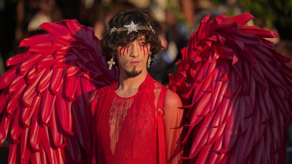 A person wears a red outfit during the Bucharest Pride 2021 in Bucharest, Romania, Saturday, Aug. 14, 2021. The 20th anniversary of the abolishment of Article 200, which authorized prison sentences of up to five years for same-sex relations, was one cause for celebration during the gay pride parade and festival held in Romania's capital this month. People danced, waved rainbow flags and watched performances at Bucharest Pride 2021, an event that would have been unimaginable a generation earlier. (AP Photo/Vadim Ghirda)