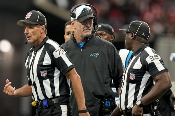 Carolina Panthers head coach Frank Reich speaks with field judge Anthony Jeffries (36) during the first half of an NFL football game against the Atlanta Falcons, Sunday, Sept. 10, 2023, in Atlanta. (AP Photo/Brynn Anderson)
