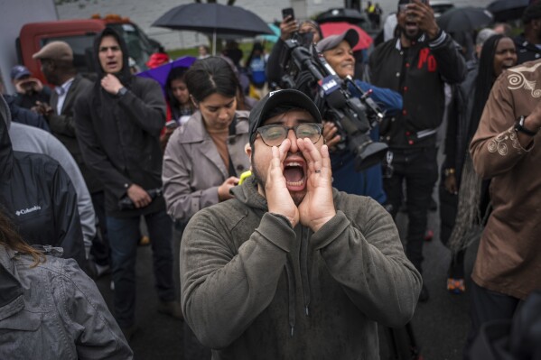 A protestor shouts, "Let him out", demanding the release of Newark Mayor Ras Baraka after his arrest while protesting at an ICE detention prison, in Newark, N.J., May 9, 2025, (AP Photo/Angelina Katsanis, File)