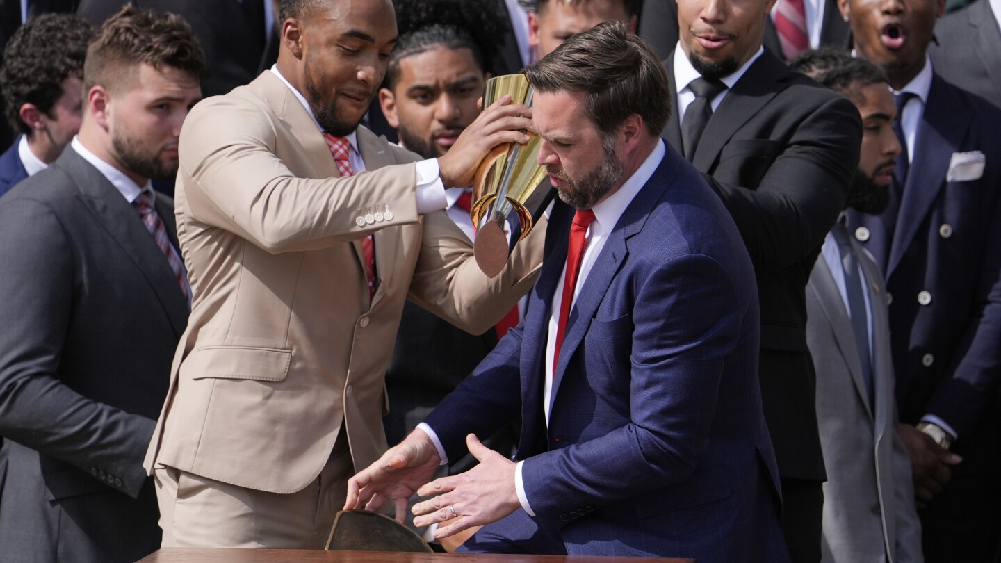 Vance fumbles Ohio State's NCAA football championship trophy as Buckeyes visit the White House