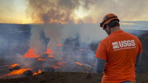 In this photo provided by the U.S. Geological Survey, a scientist monitors the ongoing eruption taking place on the summit of the Kilauea volcano in Hawaii, Wednesday, June 7, 2023. Hawaii tourism officials urged tourists to be respectful when flocking to a national park on the Big Island to get a glimpse of the latest eruption of Kilauea, one of the world's most active volcanoes. (U.S. Geological Survey via AP)
