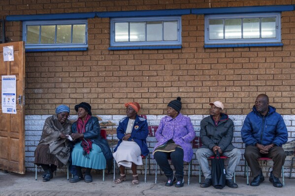 Voters line up to cast their ballots Wednesday, May 29, 2024, in the general election in Soweto, South Africa.  South African voters cast their ballots in elections seen as the most important in their country in 30 years, an election that may put them in uncharted territory in the short history of their democracy, as the ANC's three-decade dominance has become the target of early elections.  A new generation of discontent in a country of 62 million people, half of whom are estimated to live in poverty.  (AP Photo/Jerome Delay)