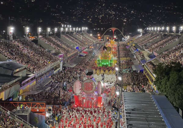 Performers from the Unidos de Padre Miguel samba school dance during Carnival celebrations at the Sambadrome in Rio de Janeiro, Sunday, March 2, 2025. (AP Photo/Silvia Izquierdo)