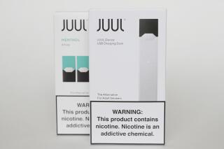 FILE - Packaging for an electronic cigarette and menthol pods from Juul Labs is displayed on Feb. 25, 2020, in Pembroke Pines, Fla. The Food and Drug Administration and Juul have agreed to suspend court proceedings while the agency conducts additional review of the company's vaping devices. The agreement Wednesday, July 6, 2022, comes one day after the FDA placed a hold on its initial order banning Juul’s products. (AP Photo/Brynn Anderson, File)