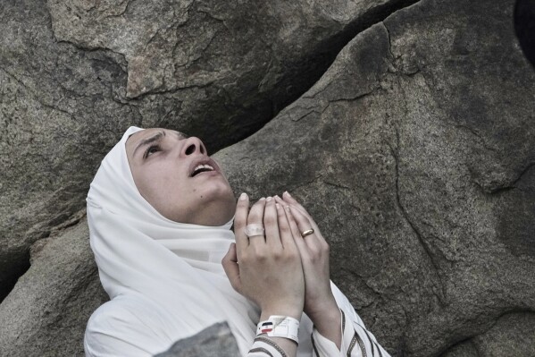 A Muslim pilgrim prays during the annual Hajj pilgrimage on the Plain of Arafat, near the holy city of Mecca, Saudi Arabia, Thursday, June 5, 2025. (AP Photo/Amr Nabil)