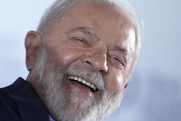 Brazil's President Luiz Inacio Lula da Silva smiles during a meeting with mayors from all over the country to discuss public policy issues and the federal government's support for municipalities, in Brasilia, Brazil, Tuesday, March 14, 2023. (AP Photo/Eraldo Peres)