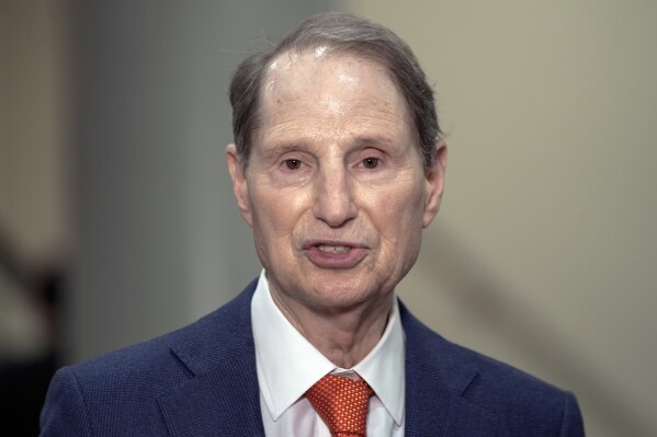 FILE - Sen. Ron Wyden, D-Ore., speaks with reporters on Capitol Hill on March 20, 2024, in Washington. A Senate inquiry has found BMW, Jaguar Land Rover and Volkswagen have bought parts made by a Chinese company sanctioned under a 2021 law for using forced labor. "Automakers are sticking their heads in the sand and then swearing they cannot find any forced labor in their supply chains," said Wyden. "Automakers' self-policing is clearly not doing the job." (AP Photo/Mariam Zuhaib, File)