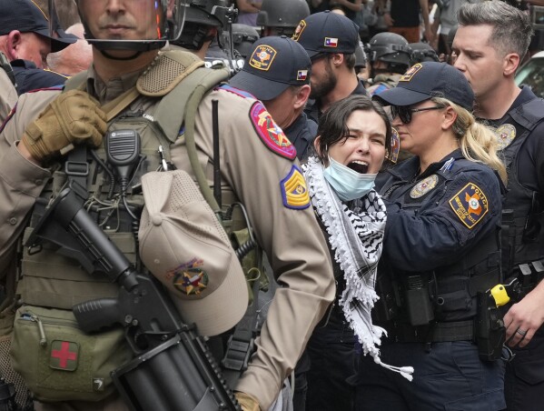 A woman is arrested at a pro-Palestinian protest at the University of Texas, Wednesday, April 24, 2024, in Austin. (Austin American-Statesman via AP)