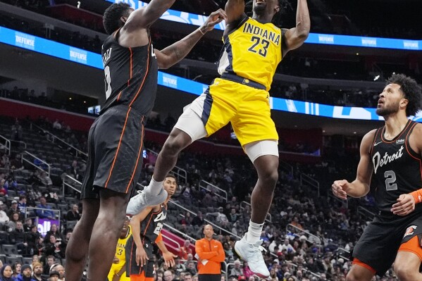 Indiana Pacers forward Aaron Nesmith (23) is defended by Detroit Pistons center Jalen Duren during the first half of an NBA basketball game, Wednesday, March 20, 2024, in Detroit. (AP Photo/Carlos Osorio)