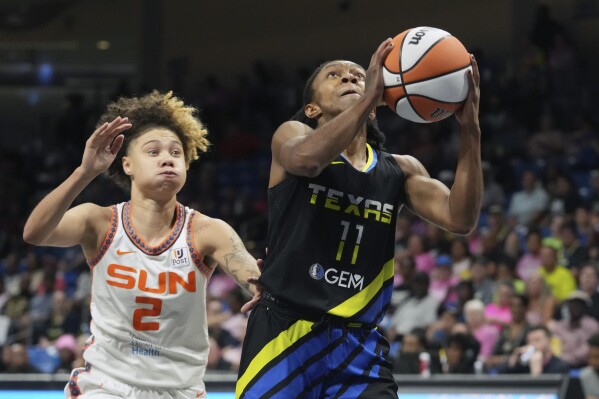 Dallas Wings guard Crystal Dangerfield (11) shoots next to Connecticut Sun guard Natisha Hiedeman (2) during the first half of a WNBA basketball basketball game in Arlington, Texas, Saturday, Aug. 12, 2023. (AP Photo/LM Otero)